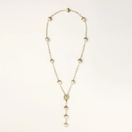 Gold-plated lariat necklace with baroque pearls and textured caps on cream background, showing adjustable Y-shaped design.