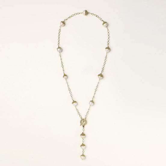 Gold-plated lariat necklace with baroque pearls and textured caps on cream background, showing adjustable Y-shaped design.