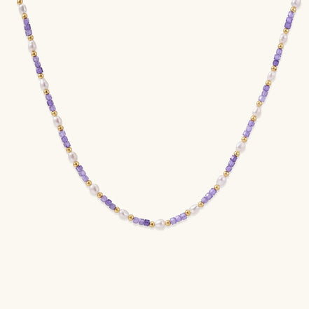 Delicate 18K gold vermeil necklace with alternating lavender zirconia beads and white freshwater pearls on cream background