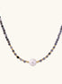 Dainty necklace with faceted purple iolite beads, gold vermeil accents, and central pink-white freshwater pearl.