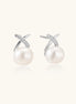 Rhodium-plated silver stud earrings with sparkling X design above lustrous round freshwater pearls on white background.