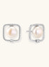 Rhodium-plated silver stud earrings with cushion frame, centered freshwater pearl, and tiny crystal accent