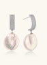 Rhodium-plated silver curved stud with pave stones and baroque pearl drop on white background