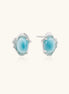 Oval larimar gemstone studs with ornate silver settings showing natural turquoise marbling on cream background