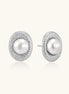 Oval rhodium-plated silver studs featuring freshwater pearls surrounded by pavé crystal halo on white background