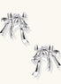 Sculptural bow earrings in polished white gold plate with sparkling zirconia stones and flowing ribbon details