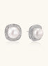 Cushion-shaped sterling silver stud earrings with freshwater pearls surrounded by geometric diamond halos