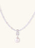 Dainty necklace with lavender crystal beads, freshwater pearls, geometric pendant, and large pearl drop on white background.