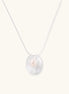 Sterling silver disc necklace with textured finish and centered freshwater pearl on delicate chain