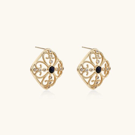 Gold filigree stud earrings with navy lapis lazuli center stone and mother-of-pearl accents in ornate quatrefoil design