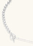 Long sterling silver beaded necklace with graduated sphere design, toggle clasp, and delicate chain extension on white background